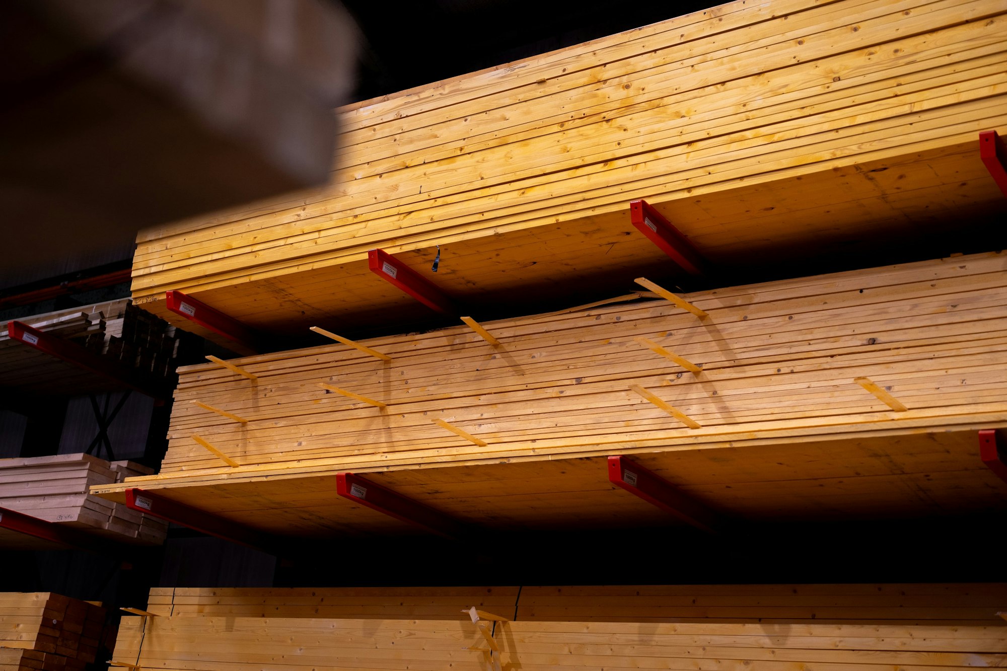 Stacked lumber in a light-industrial warehouse, representative of Prairie Crossing's light manufacturing sector.